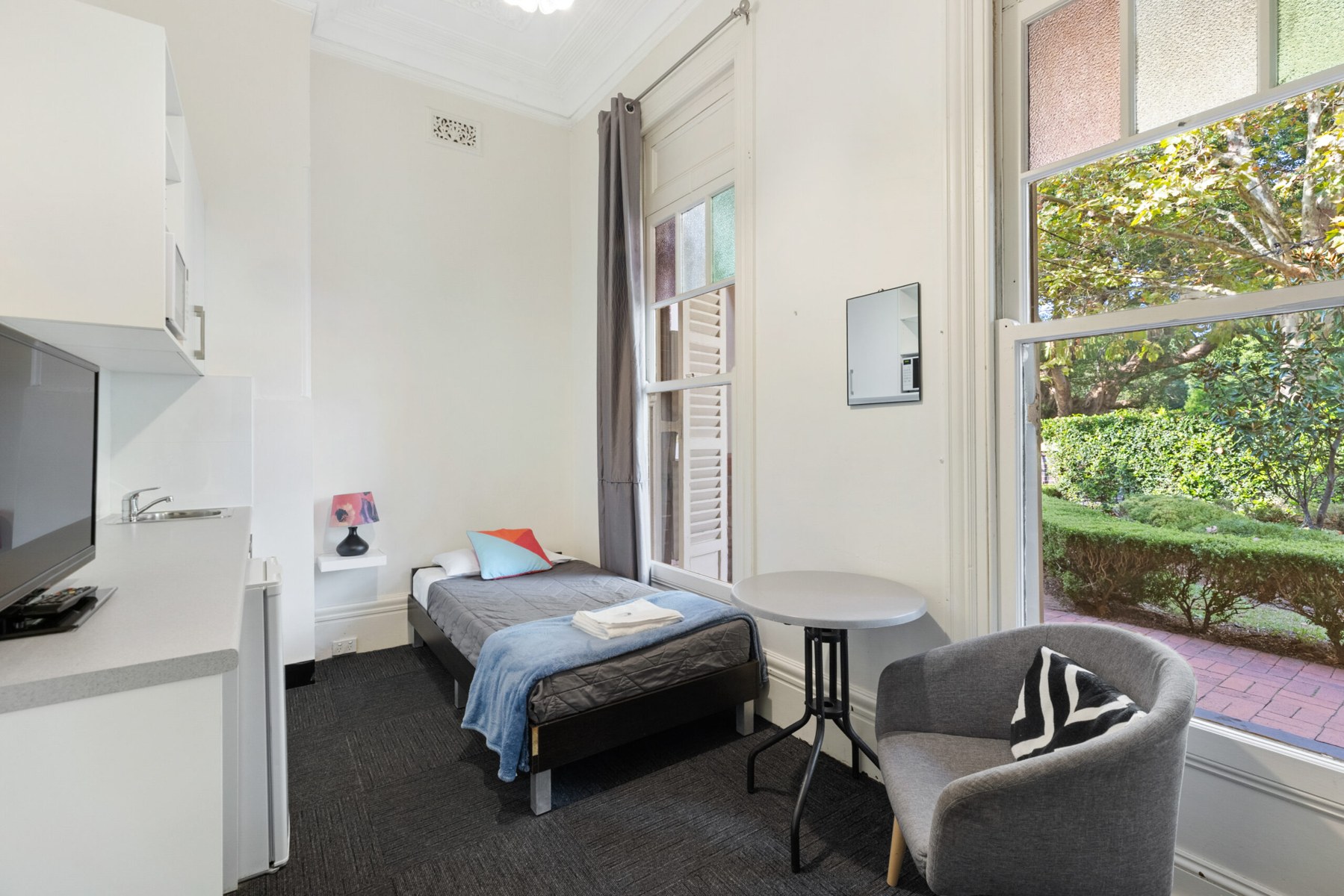 Single room at Falcon Lodge with kitchenette and desk